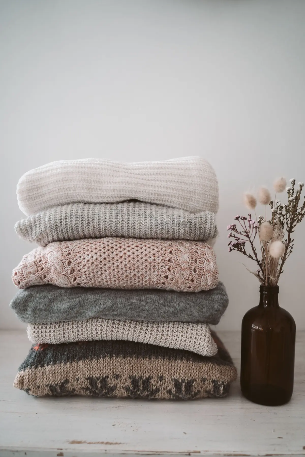 Stacked luxury knitwear representing hypoallergenic human-derived fibre
